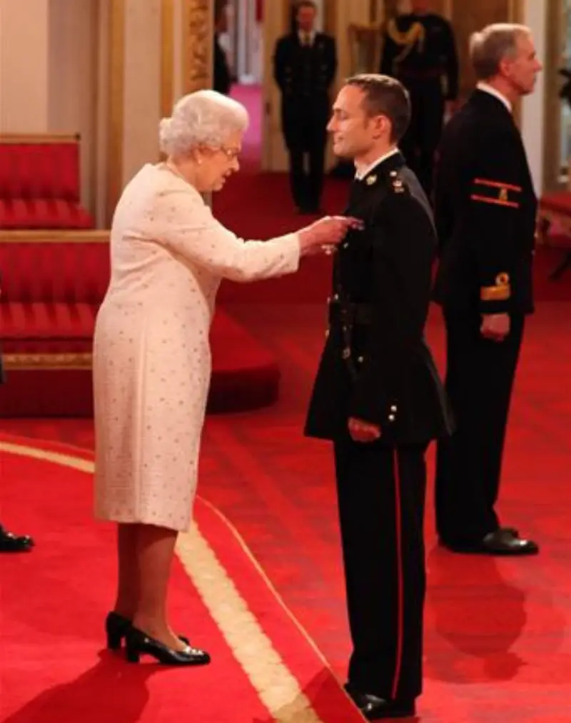 Niki Richard Dalgliesh Cavill in front of Queen Elizabeth II