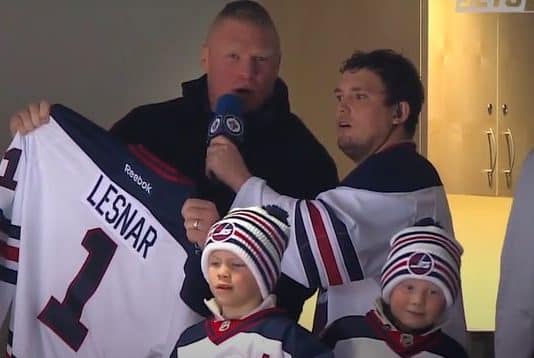 Brock Lesnar with his Duke and Turk at a hockey game