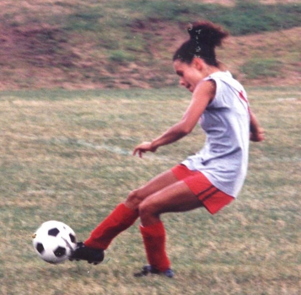 Young Joy Taylor playing soccer