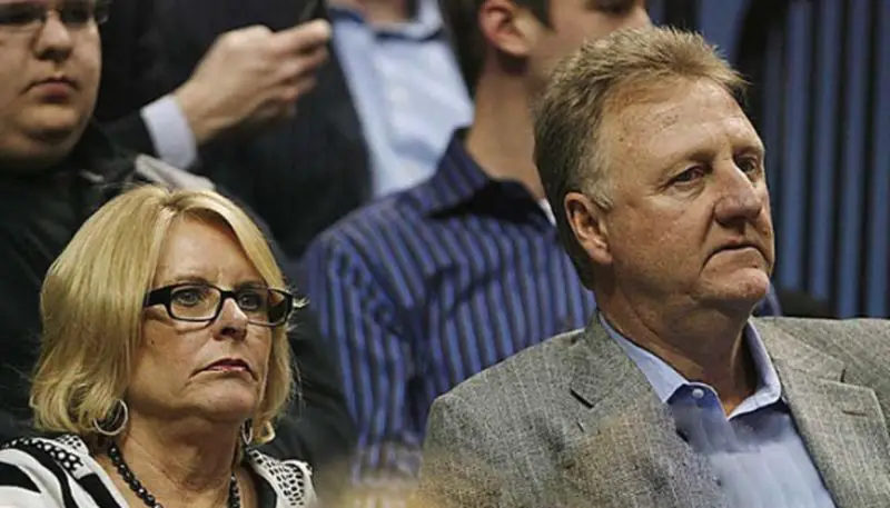 Larry Bird and with his wife Dinah Mattingly at a game
