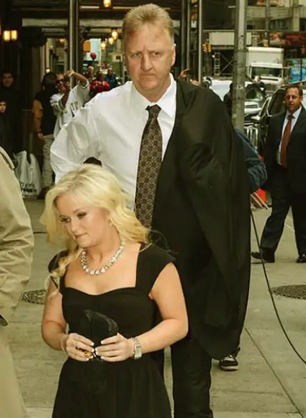 Larry Bird walking with his adoptive daughter Mariah Bird