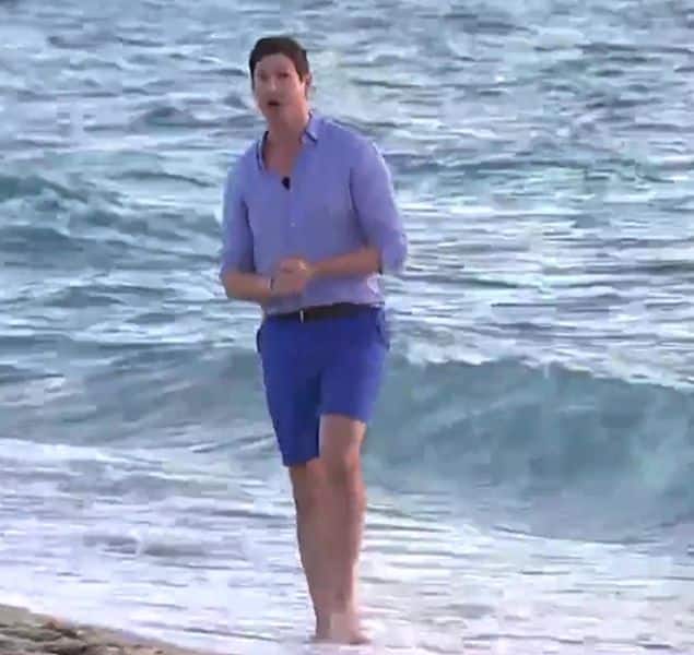 Sam Brock wearing shorts during live air reporting.