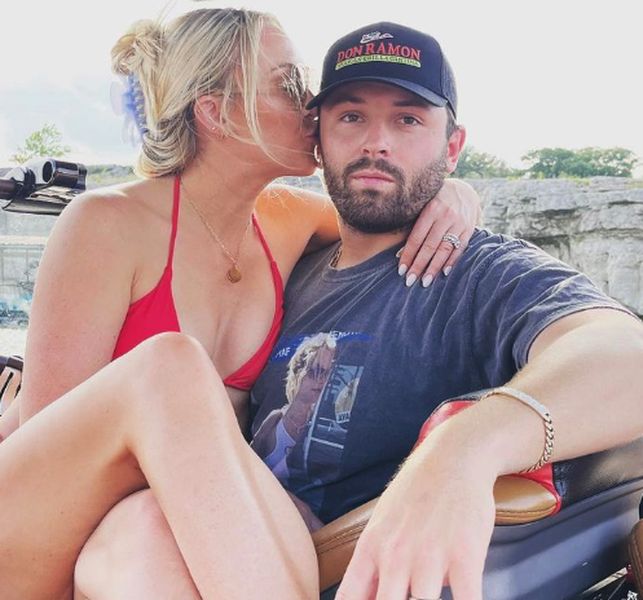 Emily Wilkinson with he husband Baker Mayfield on a beach